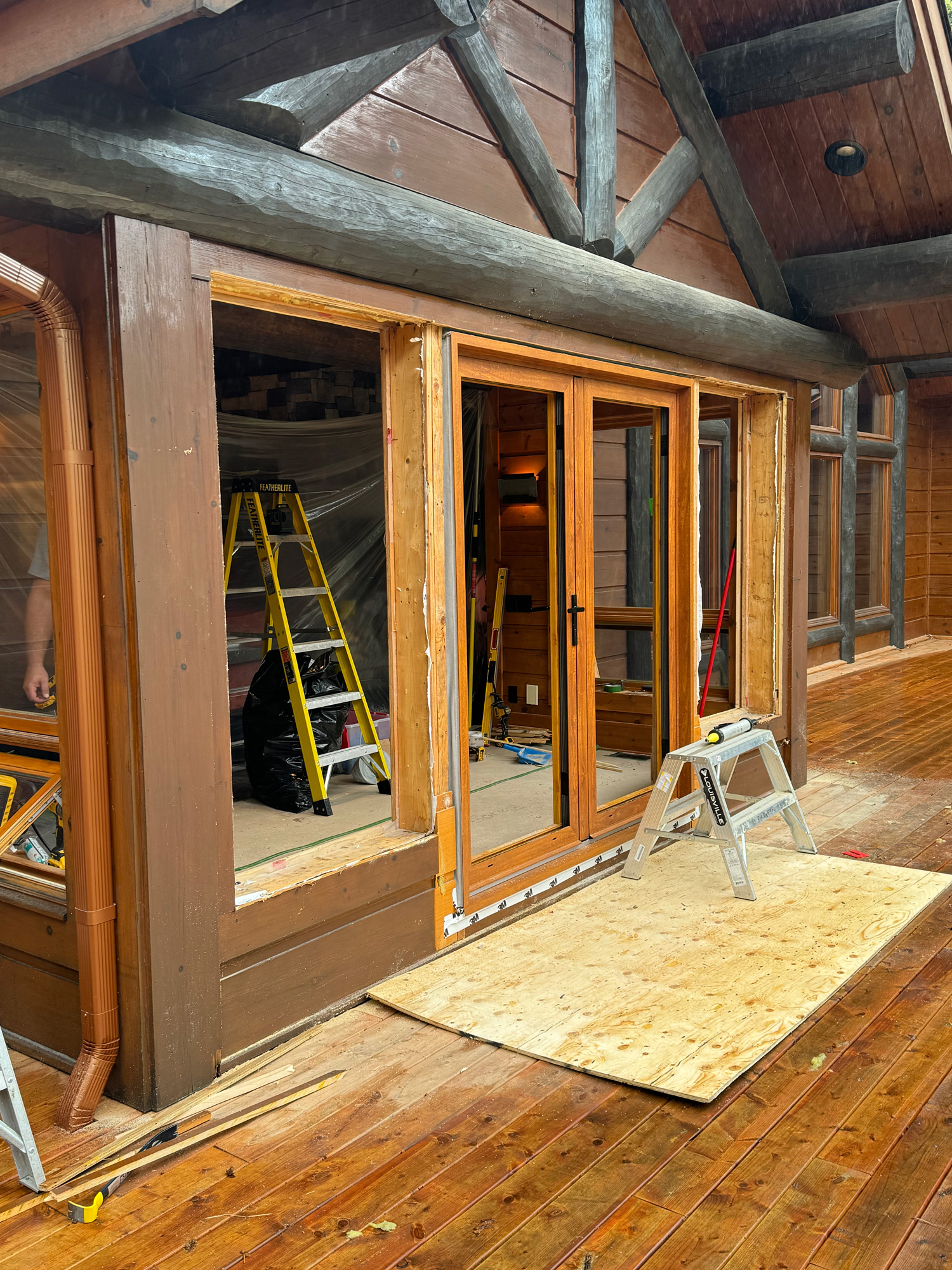 Reynaers Aluminum MasterLine 8 French door installed during cottage renovation, with adjacent window openings not yet prepared for windows.