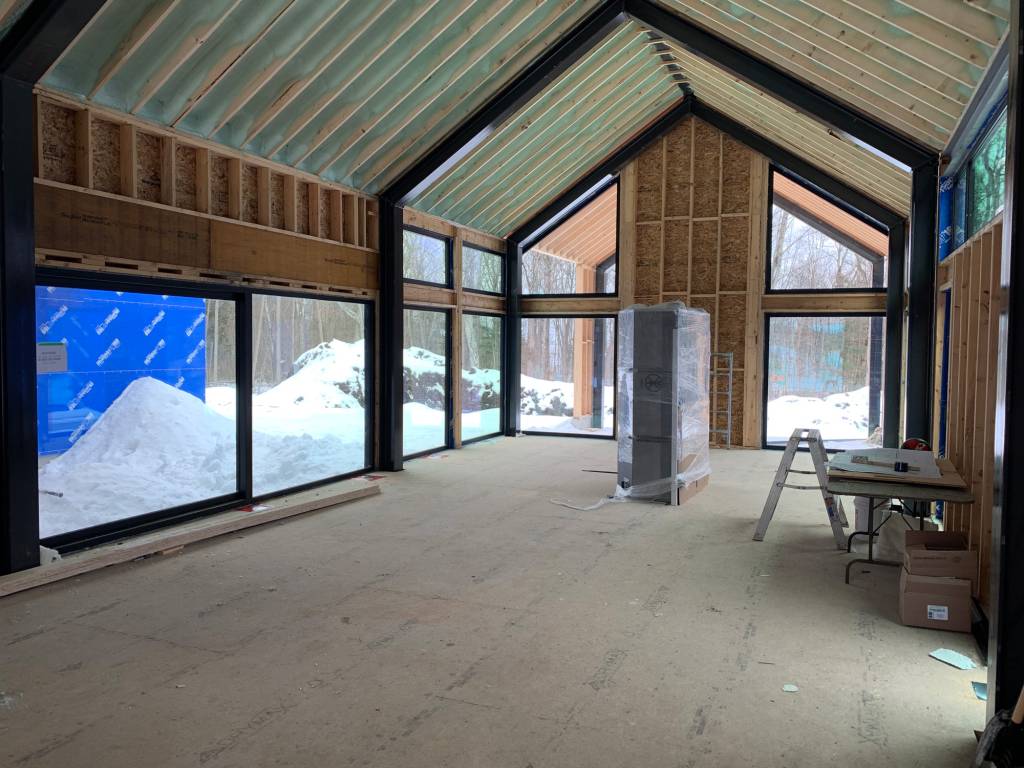 Interior view of the great room in a Barrie home under construction, featuring Reynaers SL38 slim windows and CP130LS lift sliding doors.