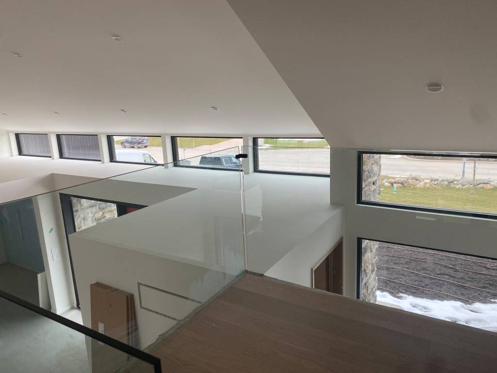 Interior of a Blue Mountains modern home with Reynaers SL38HI clerestory transom windows designed to bring natural daylight deep into the living space.